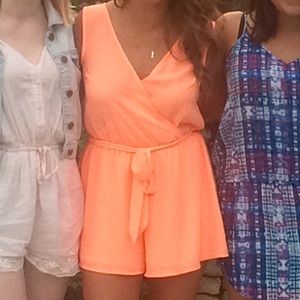 Coral romper with tie around waist